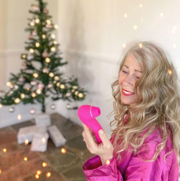 Mr. & Mrs. Vibe Couples Intimacy Bundle with clitoral stimulator in vibrant pink, enhancing bedroom experience.