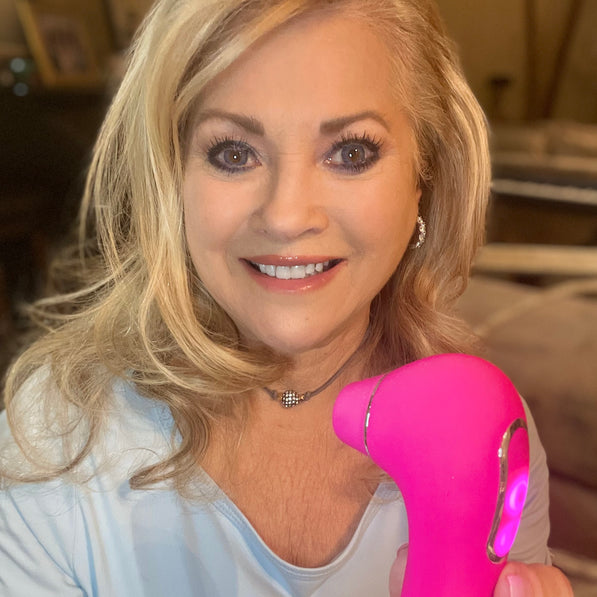 Woman holding a pink intimate pleasure device from VIVA, featuring a sleek design and LED light.
